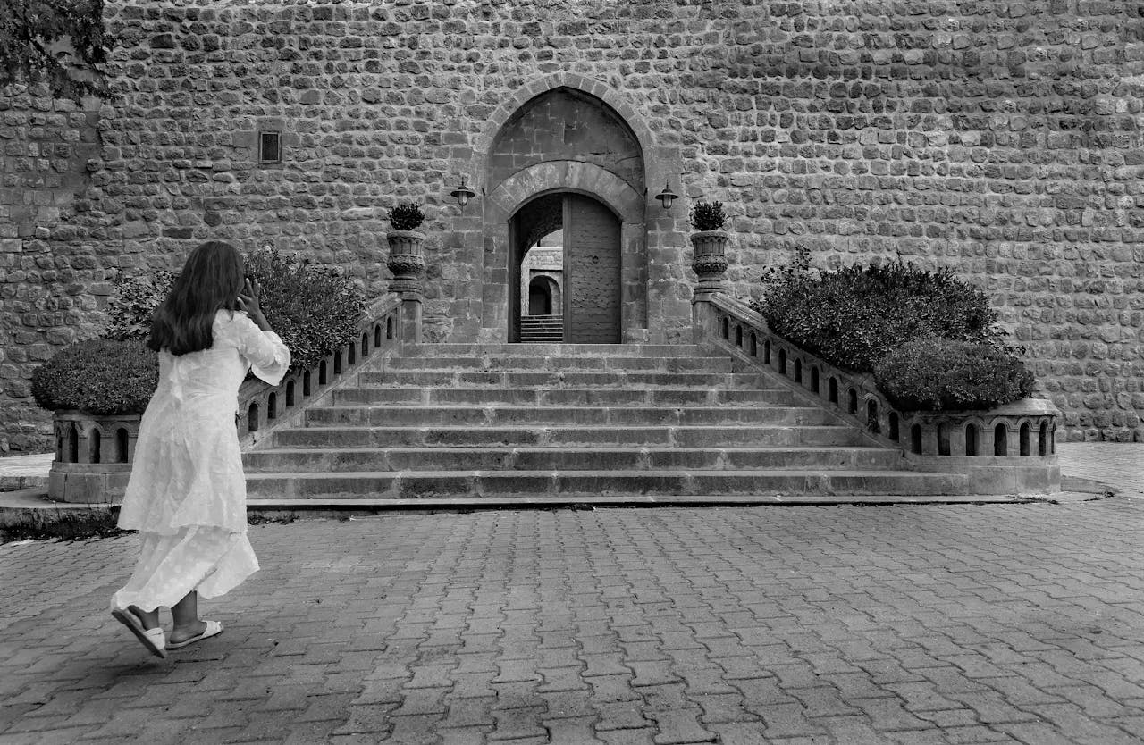 historical-stone-entrance-with-woman-in-motion-32576198